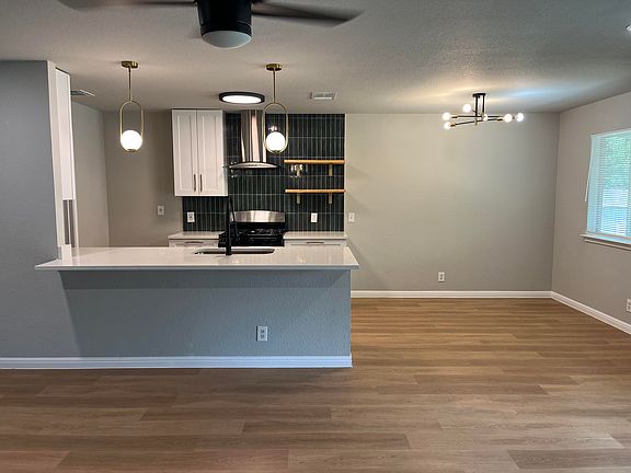 open floorplan with kitchen and dining open to the living area