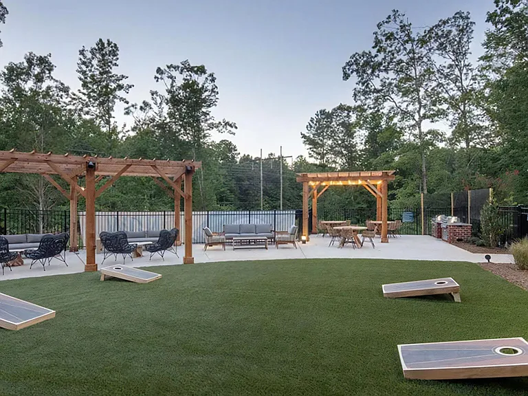Outdoor Courtyard with Pergola Lounge, Lawn Games, and Dining Area
