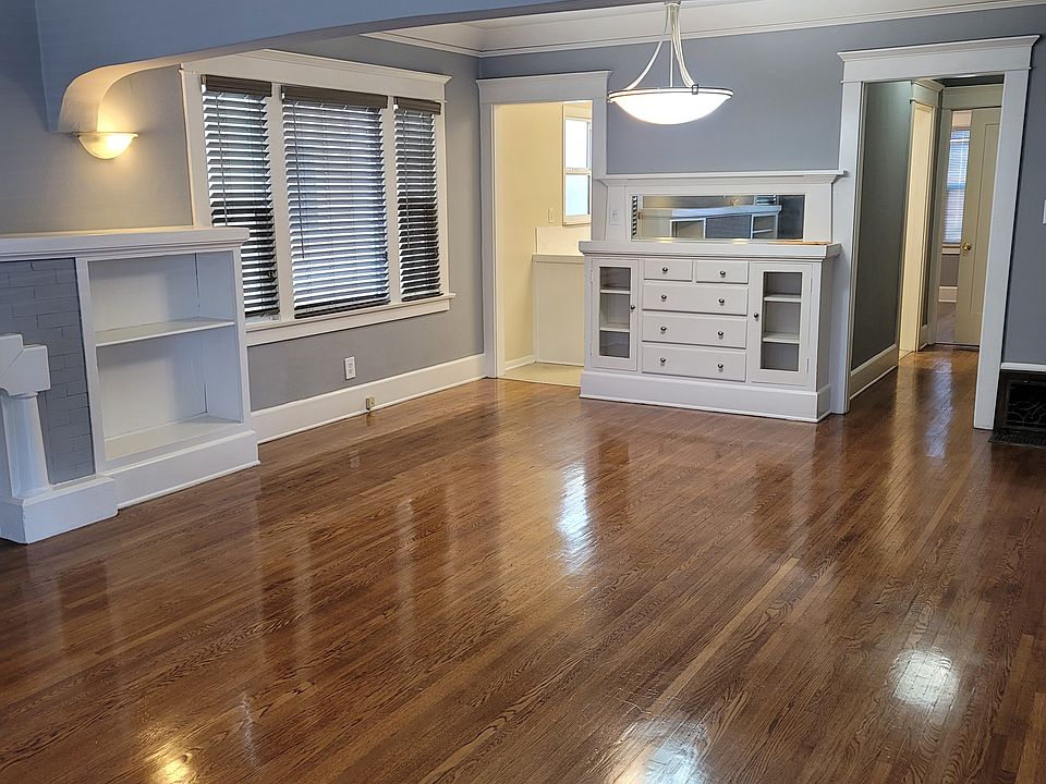View, front door looking into dining room. Kitchen and hallway in the background.