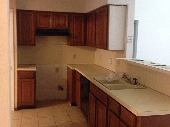 kitchen with pantry and snack bar overlooking living room.