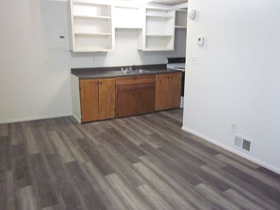 Part of living room, looking into kitchen