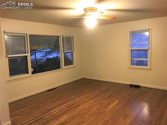 Living Room with newly refinished Wood Floor and Picture Window