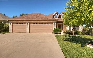 Three car oversize garage with extra large parking apron.