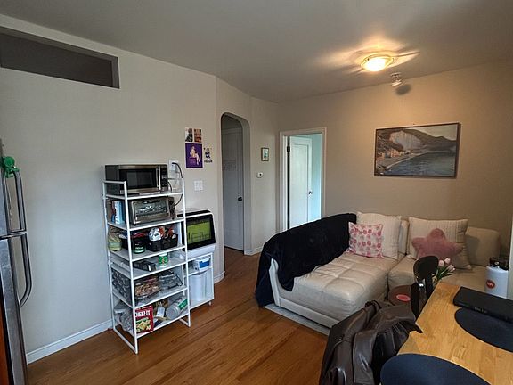 Living/dining area. Most furnishings will be available for purchase when tenant moves.