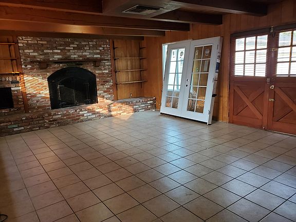 Large den with wood fireplace, or optional 4th/ Master bedroom. Barn doors are being updated with white French doors.