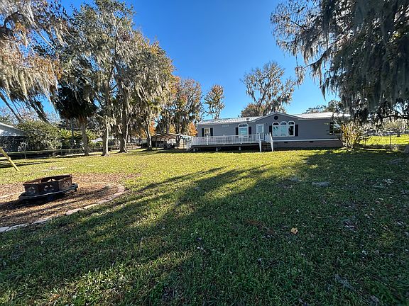 Rear of home with deck overlooking the lake