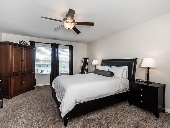 Roomy master w newer carpet and light fixture.