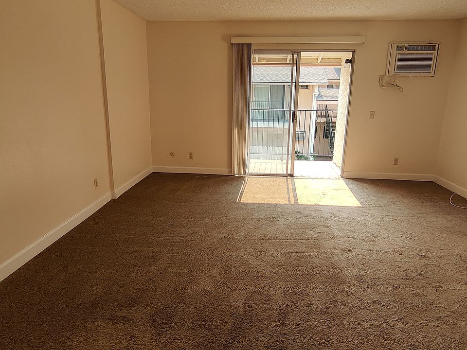 Living room, viewed from under ceiling fan in dining area.