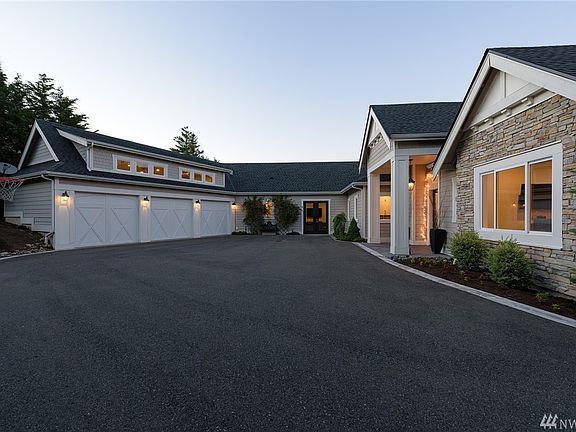 Private driveway offers ample indoor and outdoor parking and huge rec space.