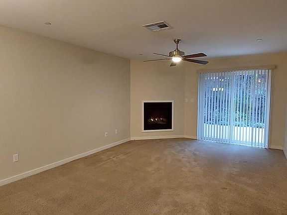 Family room has a gas fireplace and access to the fenced backyard patio.
