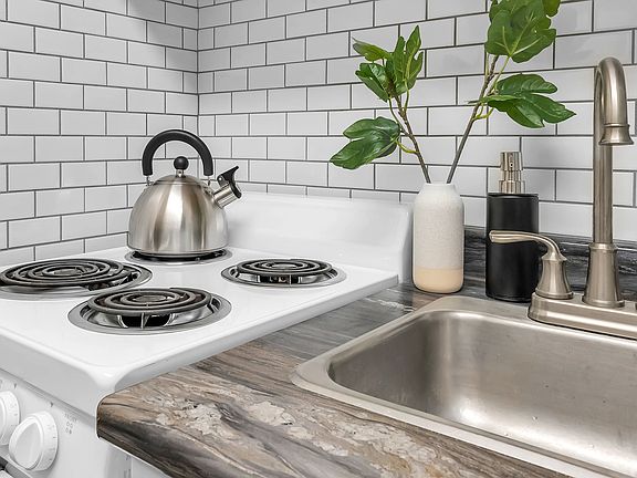 Experience elegance with our premium white subway tile backsplash, a signature element of our chic Chicopee apartments.