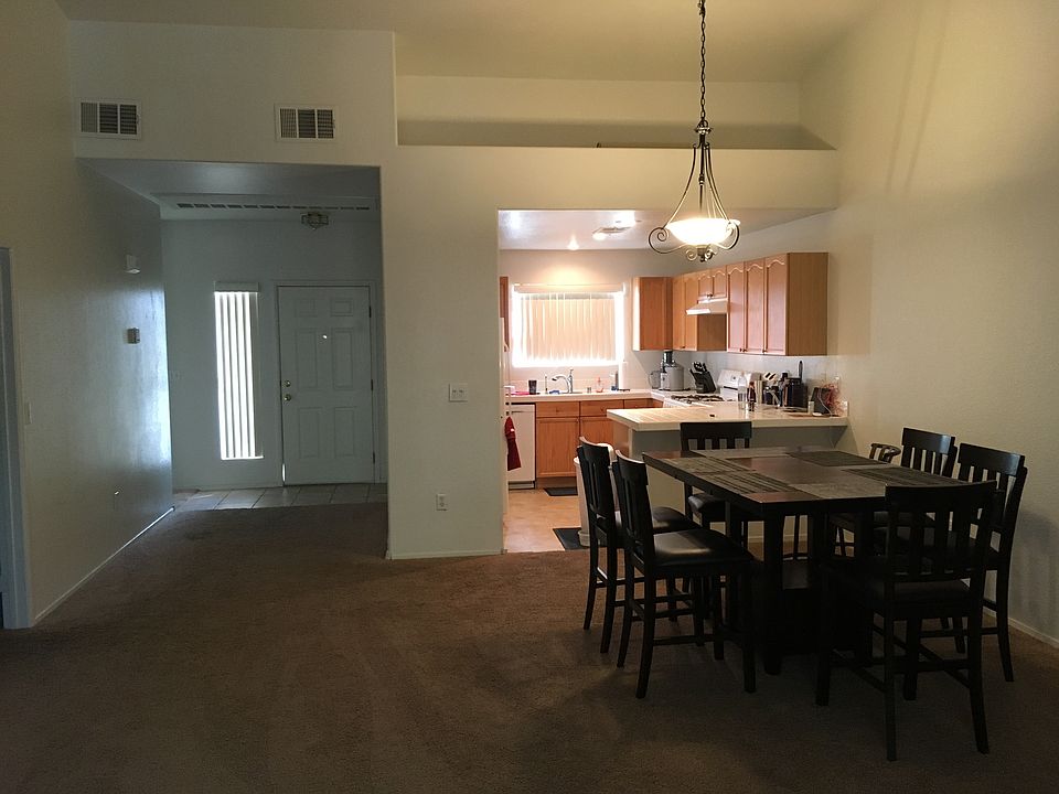 Living area and kitchen with high vaulted ceilings
