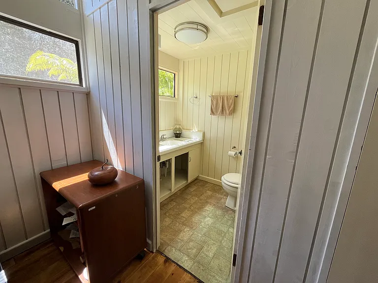 Half bath adjacent to primary bedroom. Self-sustaining Opae Ula (little Hawaiian Red Shrimp) are in two small fish bowls on the counter. Watch them frolic as you brush teeth in the morning.