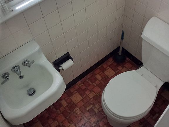 Half bath next to washing machine.