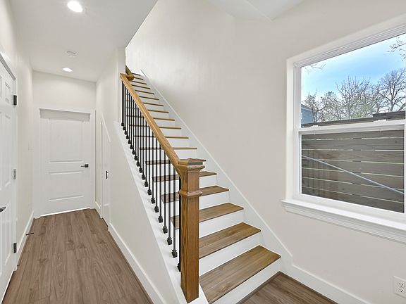entry way leading to 1st floor bedroom & first stairwell. Left door is the garage door entrance