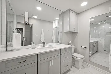 Redone primary bathroom with custom cabinetry provides amply storage and a spa like bathroom.