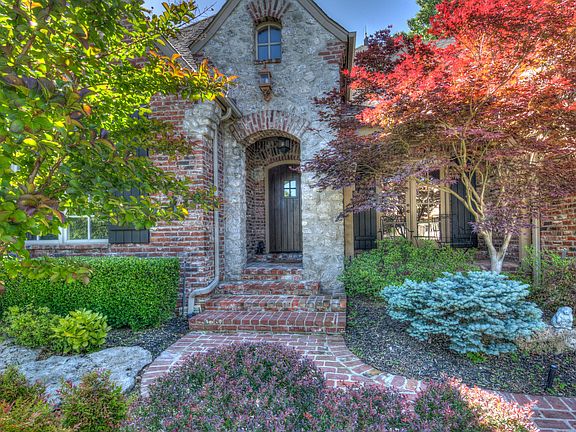 A curved brick pathway will lead you to the front entrance of the home. Notice the stunning landscap