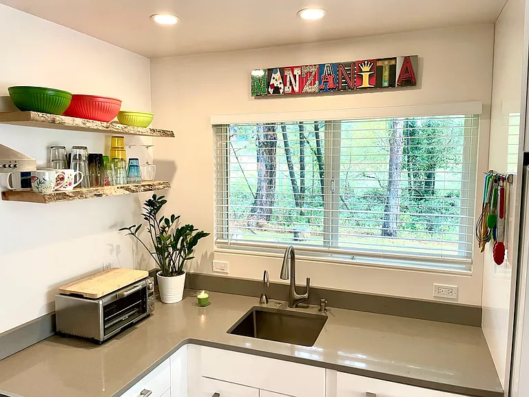 Clean, light and bright ... view out onto the backyard. You'll notice the Instahot dispenser to the left of the faucet - great for tea or french press coffee any time of day.