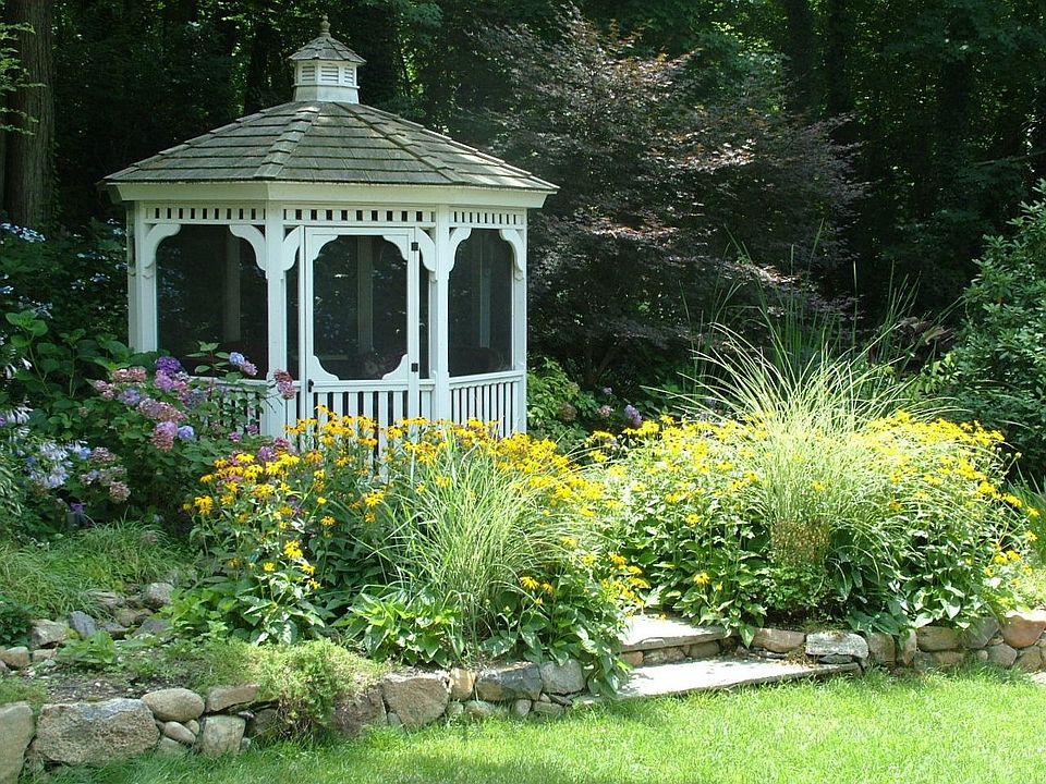 Backyard gazebo next to pond and waterfall
