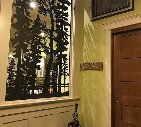 Custom built metal art graces the front hallway as you enter the home.