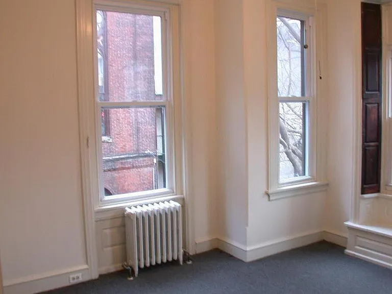First bedroom from the hallway, with a ceiling fan and light. closet