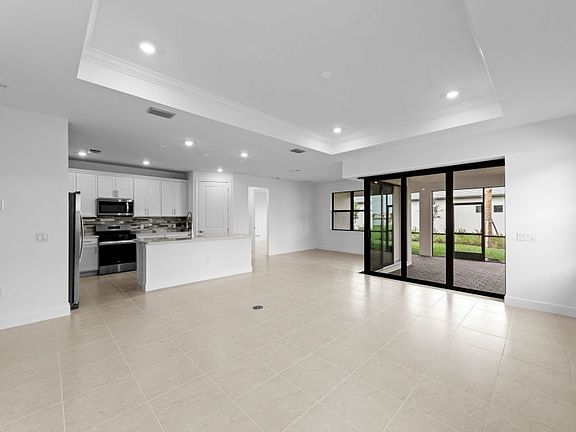 Spacious gathering room featuring a drop tray ceiling