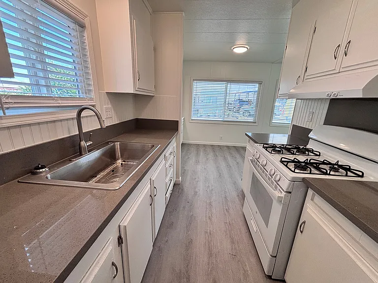 The kitchen is thoughtfully designed to blend functionality with everyday comfort. Featuring ample cabinetry and generous counter space, it provides plenty of room for meal preparation and storage.