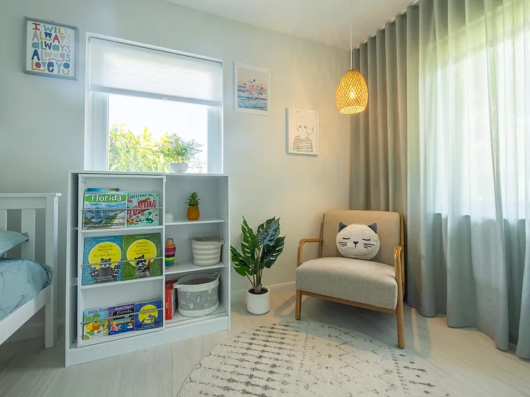 Kids bedroom with full size bunk bed (full size on the first level and twin size on the top level). Designer wall mural, toys.
