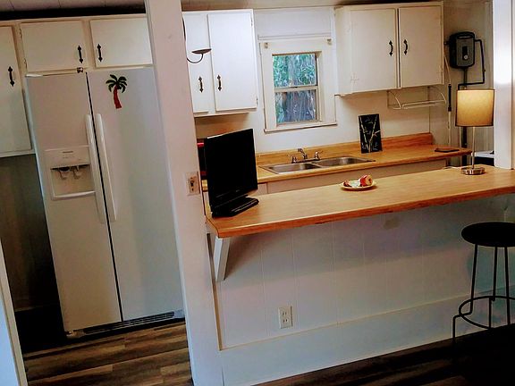 View of Kitchen with Side by Side Refrigerator. No dishwasher.