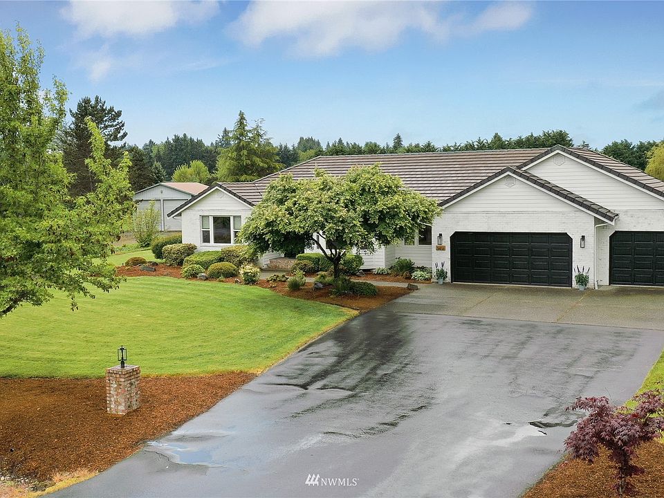 Drone view of front of home. Note nice long drive with plenty of parking for guests and 3 car garage. 