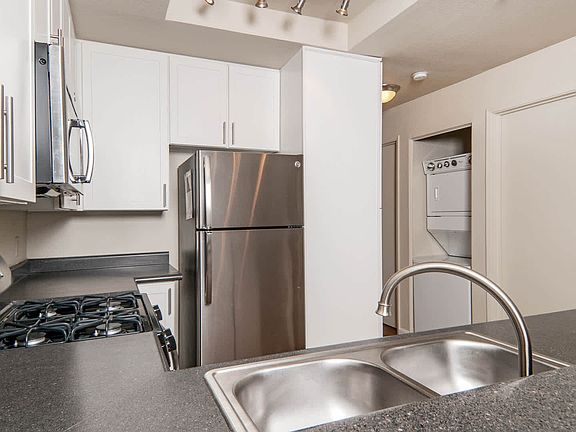 Kitchen with Stainless Steel Appliances and In-home Washer and Dryer
