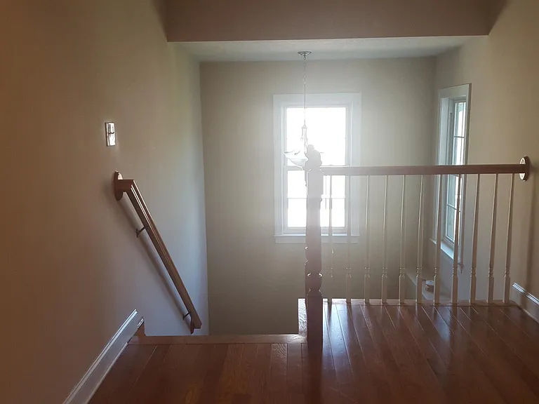 Stairway to the second floor. Hardwood floors throughout