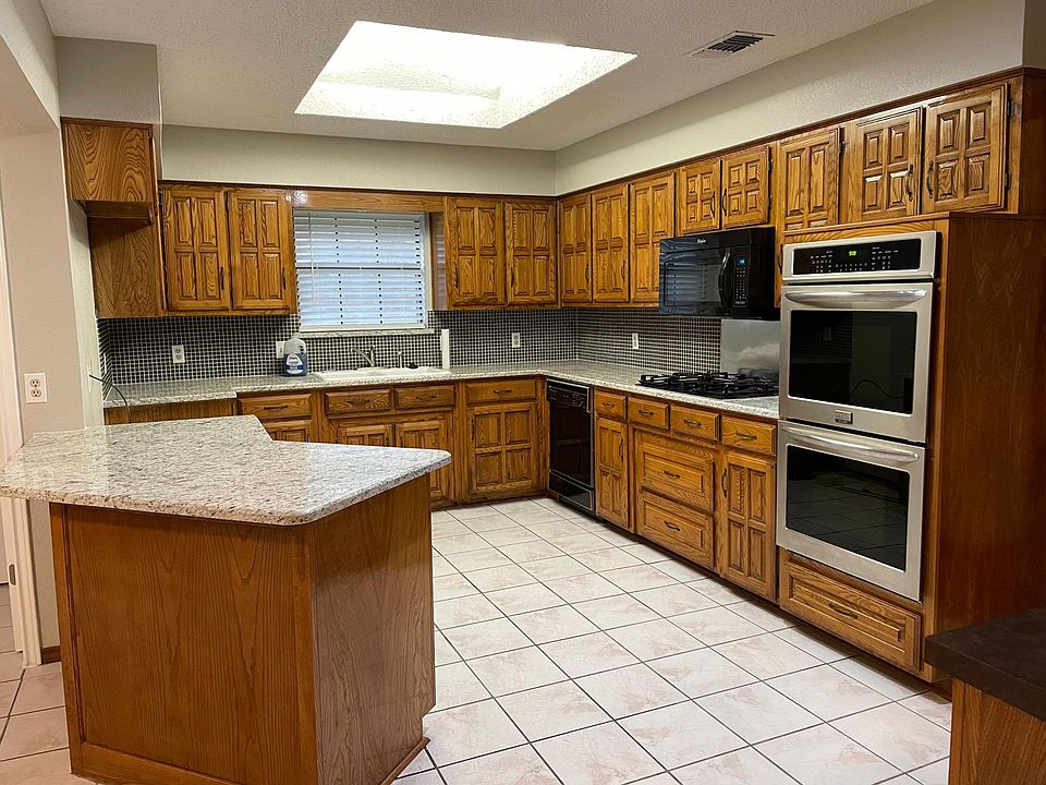 updated kitchen w/skylight, granite countertops and double, convection oven