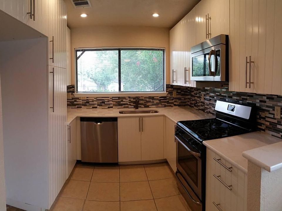 Kitchen with recessed lighting and stainless appliances