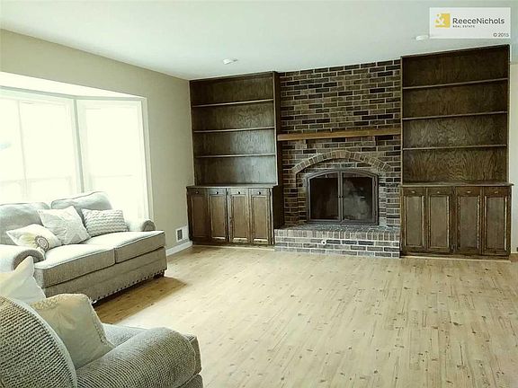 LIVING ROOM WITH FIRPELACE AND BOOK CASES