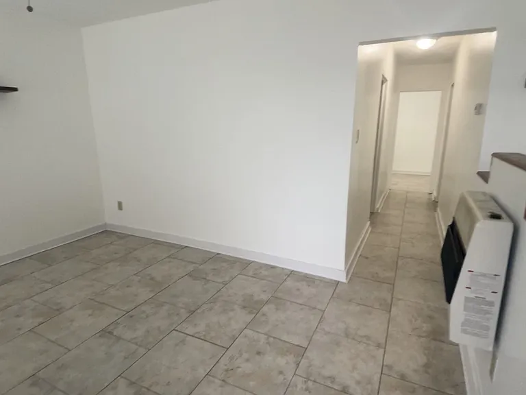 Well lit hallway to bedroom/walk-in closet, bathroom and main bedroom.