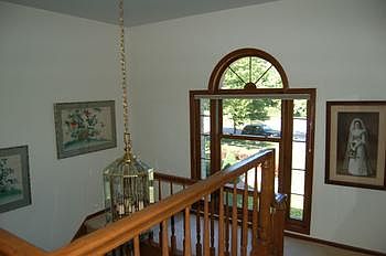 Upper hallway with a Palladian arch window. 