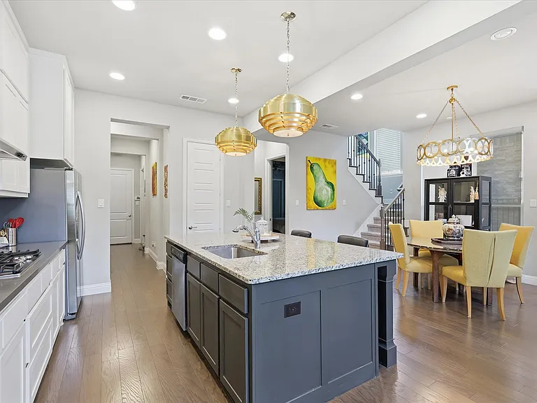 A gourmet chef's kitchen featuring an expansive central island optimized for daily meal prep or effortless entertaining.