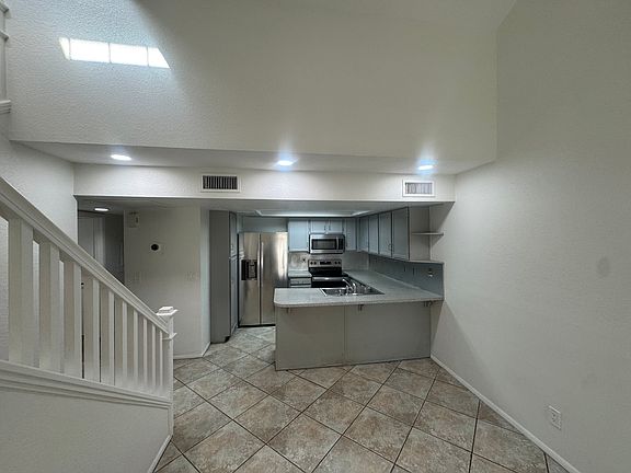 Kitchen view, new microwave stove, dishwasher, and fridge
