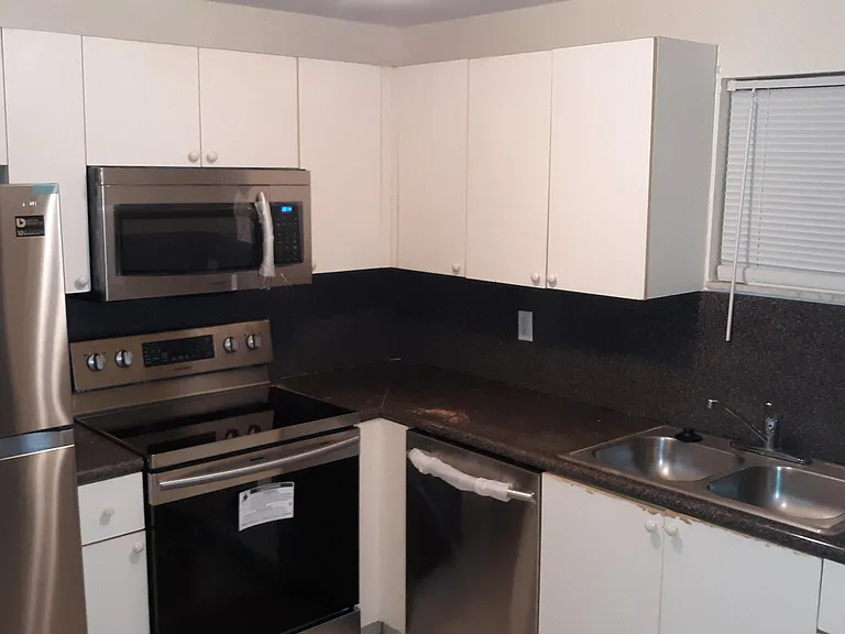 White shaker cabinets with stainless steel appliances