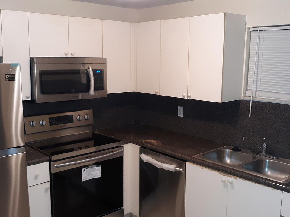 White shaker cabinets with stainless steel appliances