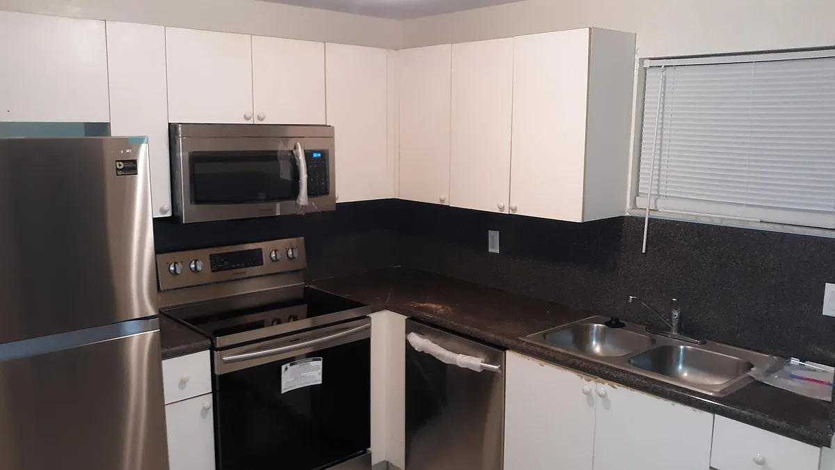 White shaker cabinets with stainless steel appliances - 4205 N University Dr