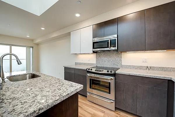 #304 Kitchen with granite counter tops.
