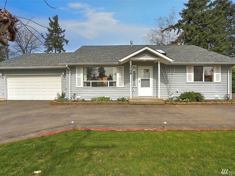 Welcome home to this charming rambler in McMicken Heights. You'll be drawn into this 2 bedroom, 2 bathroom remodeled home by the beautiful street appeal, landscaping and covered front porch. This home offers a circular drive, 2 car garage, large garden space and RV parking with RV hook-up. Enter to the spacious living room with hardwood floors, crown molding and modern, free-standing gas stove. 
