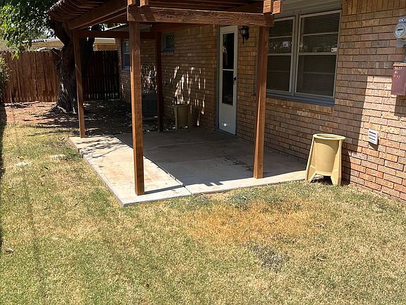 Small backyard with large covered patio.