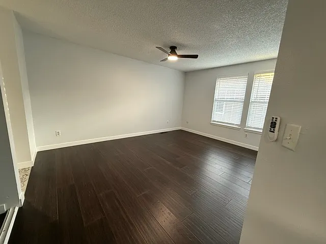 Master bedroom with ceiling fan and light plus two closets