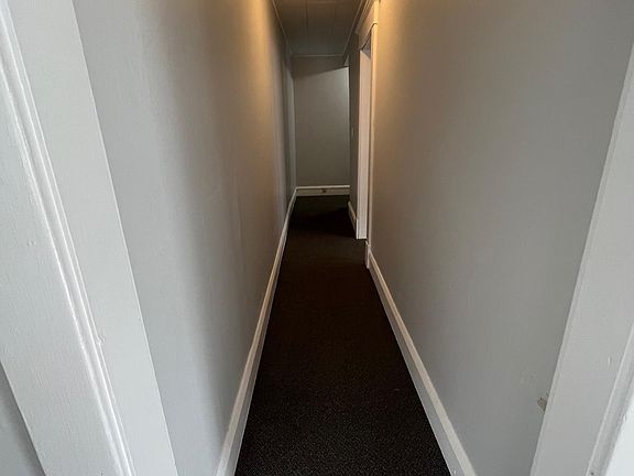 Hall from living towards bedroom, bath, kitchen and rear exit.