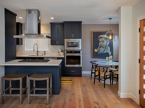 Kitchen, dining space, and counter seating at the island. Front Door to the right.
*Art and accessories might be different than shown in pictures