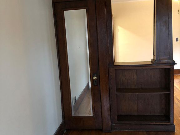 Living room - coat closet and open shelving