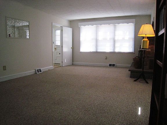 Large living room with FP and new Berber carpeting